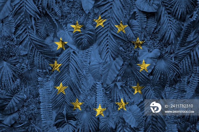 European union flag depicted on many leafs of monstera palm trees. Trendy fashionable backdrop