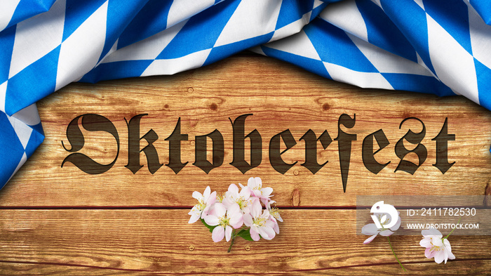 Tischtuch mit bayrischem Rautenmuster auf Holzuntergrund mit Aufschrift  Oktoberfest