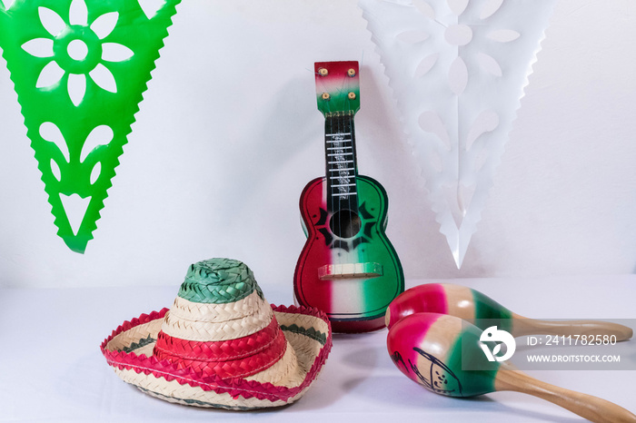 Hat, guitar, maracas and flags on white background. Mexican Independence Day decoration