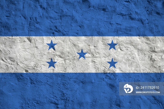 Honduras flag depicted in bright paint colors on old relief plastering wall. Textured banner on rough background