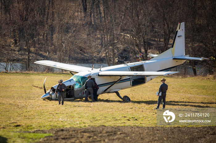 Crashed plane on field with police investigating