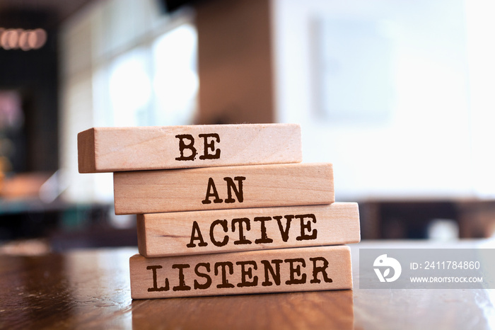 Wooden blocks with words ’Be An Active Listener’.