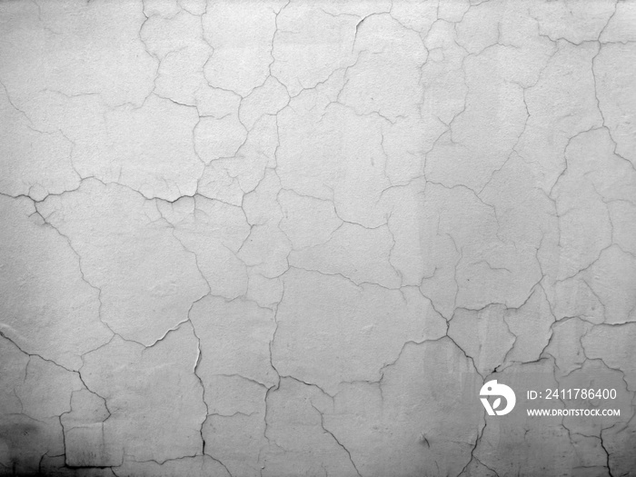 old cracked wall background texture for copy space. textured white plaster cracks for graphic design