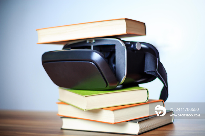 VR glasses and books on a table symbolizing digital learning