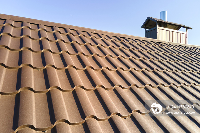 Closeup of house roof top covered with metallic shingles