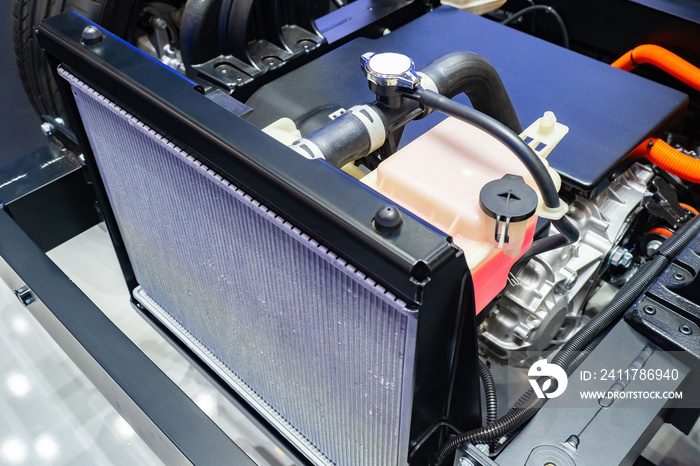 Cooling radiator inside car. Car radiator inside dismantled bonnet. Inside car. Concept - filter replacement. Installing new cooling filter. Engine cooling system repair. Car repair.