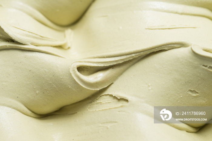 Frozen Pistachio flavour gelato - full frame detail. Close up of a creamy pastel green surface texture of Ice cream.