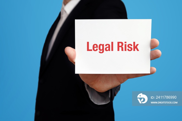 Legal Risk. Business man in a suit holds card at camera. The term Legal Risk is in the sign. Symbol for business, finance, statistics, analysis, economy