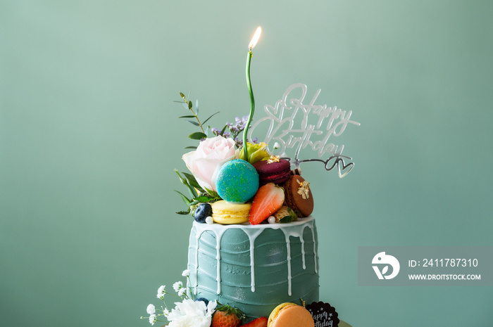 birthday cake with candles and flower,Macarons food anniversary concept cover banner background.vertical background.Birth day cake on green color background