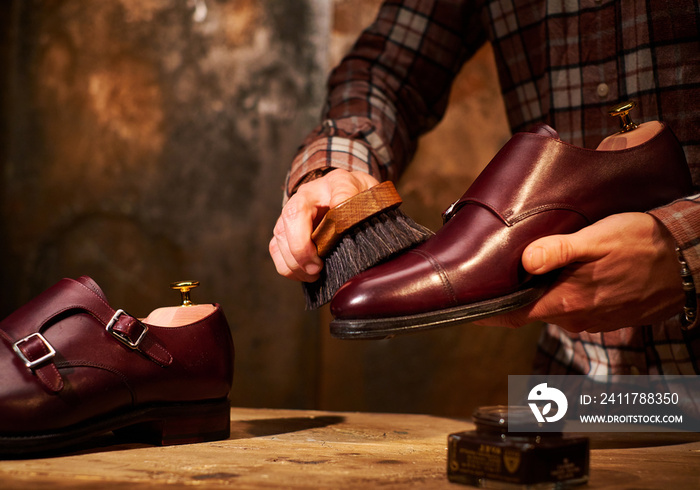 Man polishing leather shoes with brush