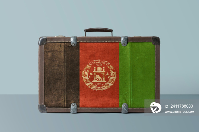 Afghanistan flag on old vintage leather suitcase with national concept. Retro brown luggage with copy space text.