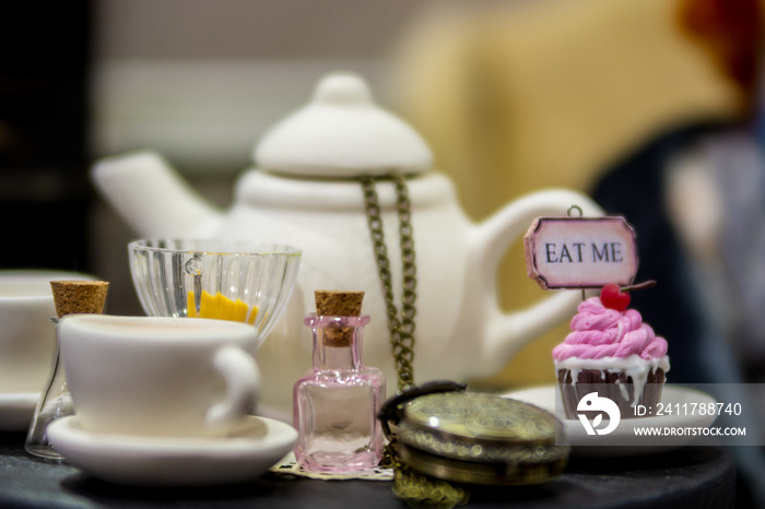 Tea-set. Cake with the inscription eat me. Can of drink. Accessories from the fairy tale Alice in Wonderland