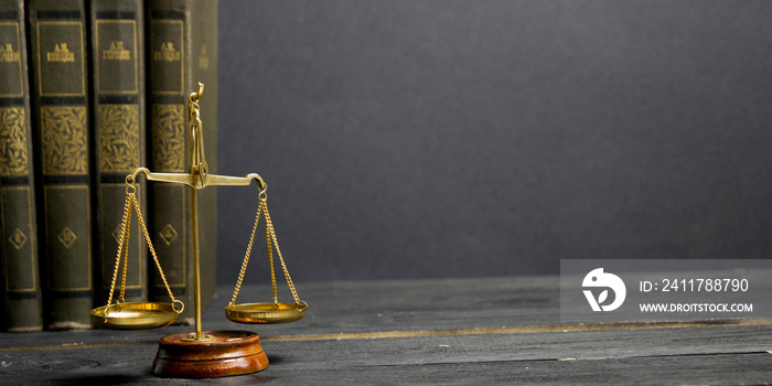 Law concept - Open law book with a wooden judges gavel on table in a courtroom or law enforcement office isolated on white background. Copy space for text