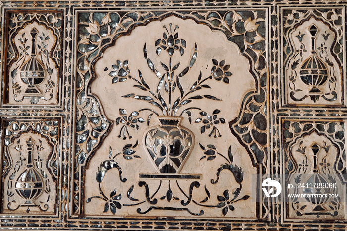 Embossed silver artwork in Amber palace, Jaipur. Floral ornament on wall in Amber Fort.