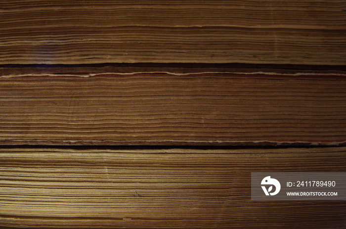 texture of yellowed pages of old books.  stack of closed old books side view