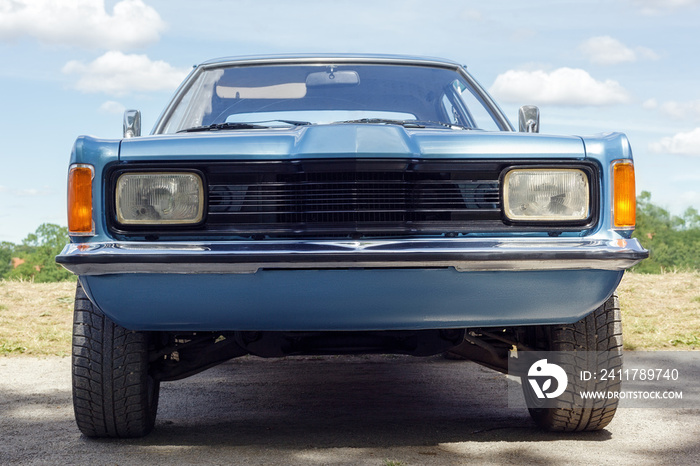 Front view of American classic blue retro car with no number plate