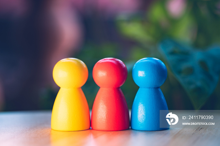 Closeup colorful wooden people on blurry background using as business and education creativity concept