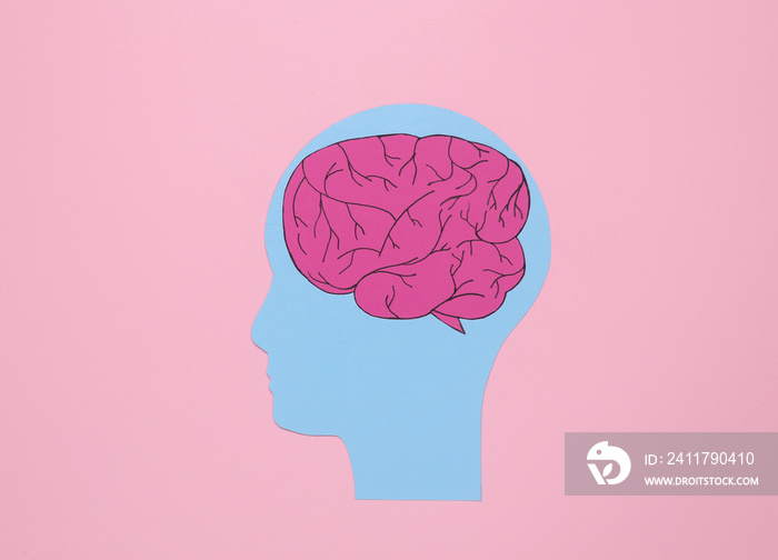 Paper cut human head with brain on pink background