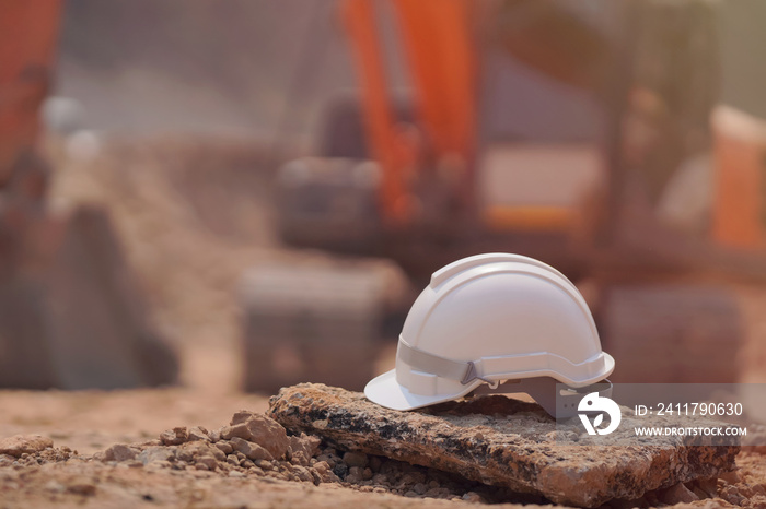 Safety helmet at construction site, road construction site background, safety concept