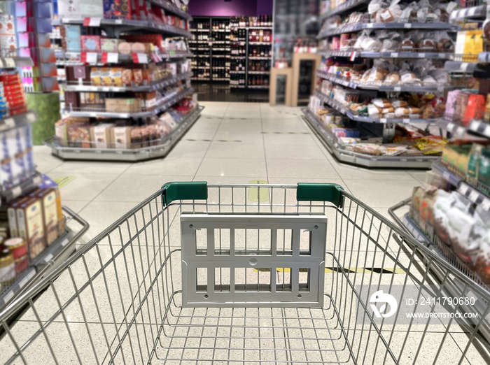 choosing a dairy products at supermarket.empty grocery cart in an empty supermarket