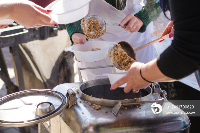 preparing a meal in the kitchen of field and feeds people on the street.