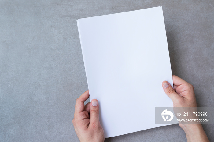 Male hands holding blank white paper