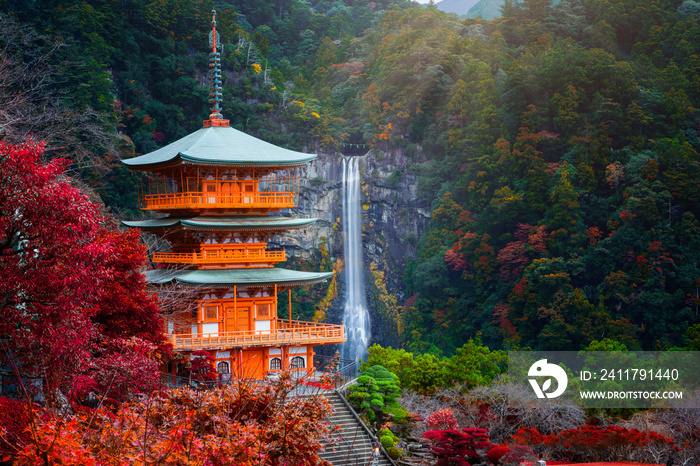 Kumano nachi taisha shrine with waterfalls along in view at season change of Autumn, the famous and popular tourist place in Kumano of Japan