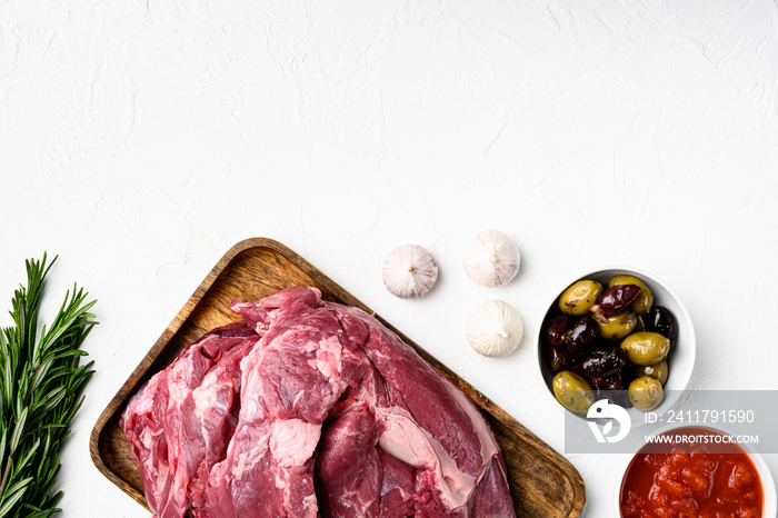 Lamb meat fresh raw, with ingredients and herbs, on white stone table background, top view flat lay, with copy space for text