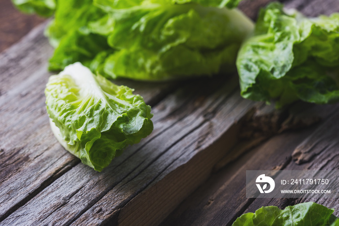 Fresh baby lettuce on wooden board