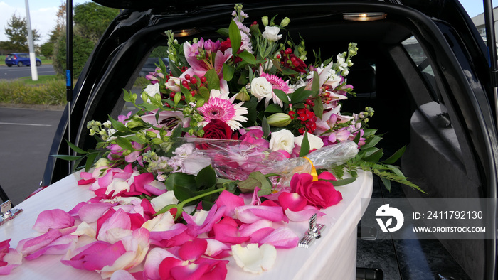 closeup shot of a funeral casket in a hearse or chapel or burial at cemetery