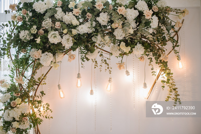 Beautiful decoration with flowers and lamps in wedding arch