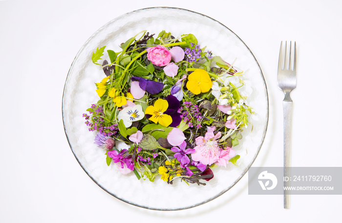 Edible flowers with young salad greens