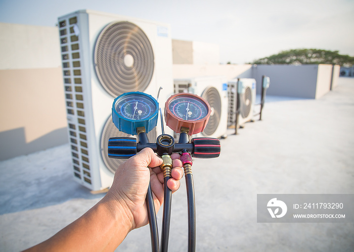 Air conditioner technician checks the operation of industrial air conditioners.