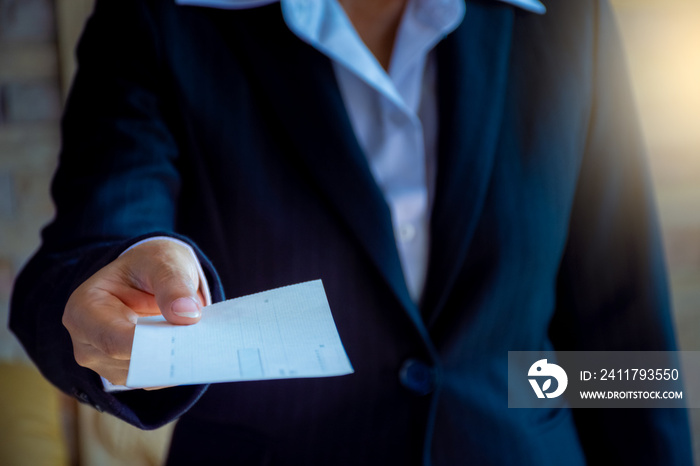 Business woman hand giving cheque.