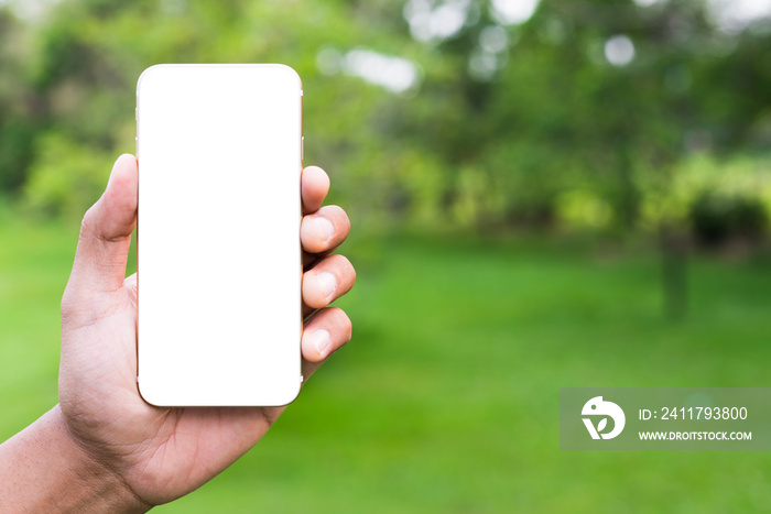 Close up hand holding blank screen of smartphone in the public park.