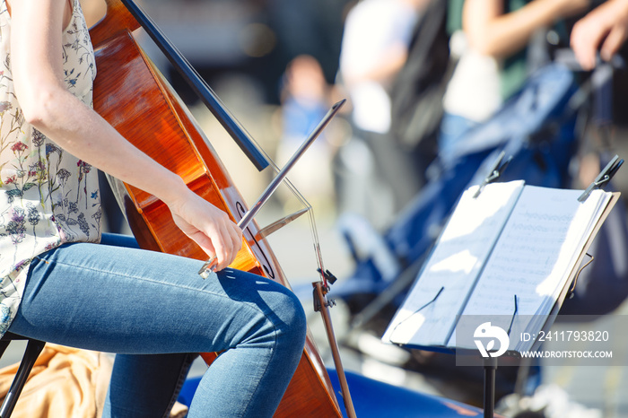 Cello player in the street among the people