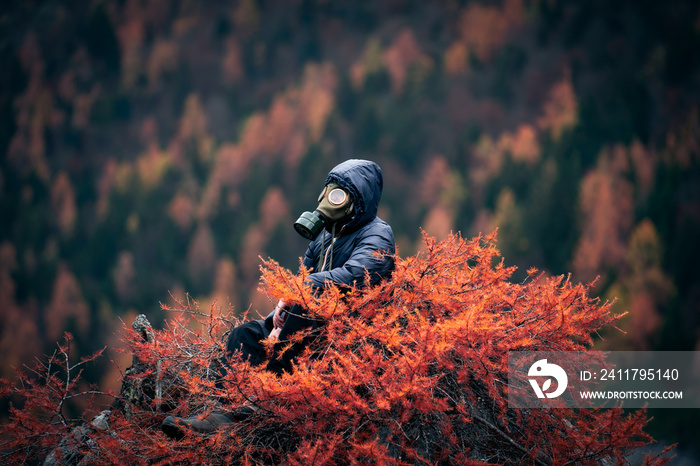 Post Apocalyptic environmental portrait with a gas mask on top of a red larch, Northern Italy