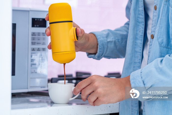 Making espresso with hands mini coffee makers at home