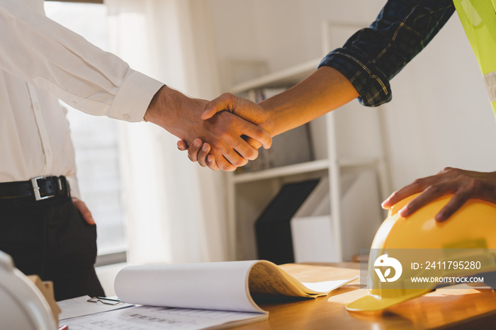 Successful team building asian young male, man or builder group handshake together at office after home project done, good deal. Happy business people, Worker meeting, shaking hands and success.