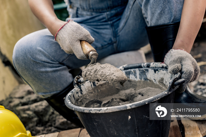 Worker repair and fix cement fence at home. DIY construction and renovate house.