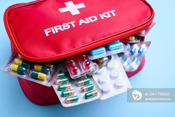 Red box full of different medicine, pills and capsules used to treat people from wide variety of illnesses and diseases