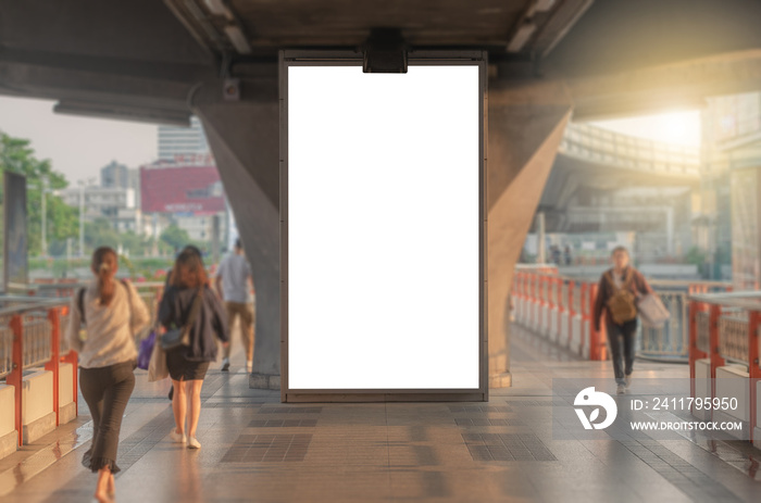 large blank advertise billboard white LED screen vertical on big concrete pole walk way outdoor in city with people walking go to working on morning.