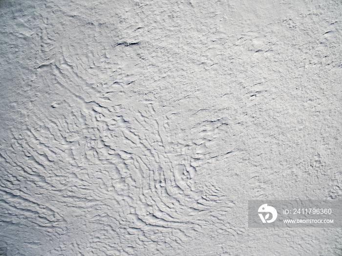 Aerial view above snowy plain  on a winter frosty day