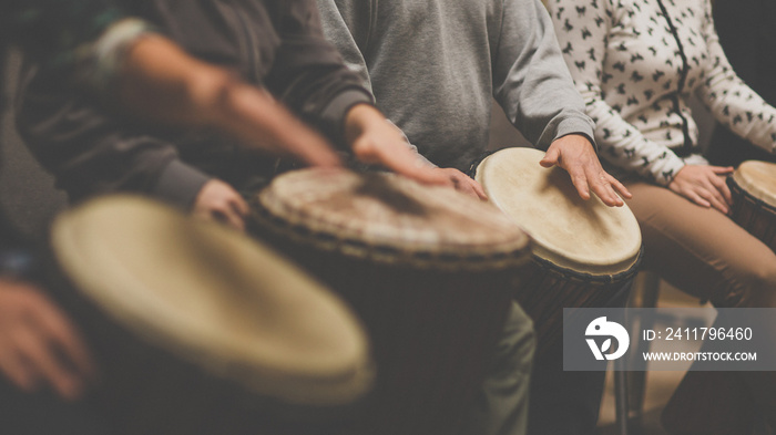 Group of people playing on drums - therapy by music