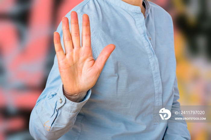 Woman signals defensive attitude with hand