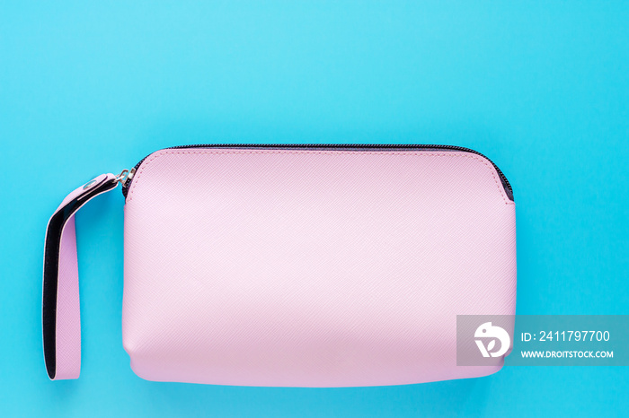 Pink lady leather bag on blue background for cosmetics and beauty concept