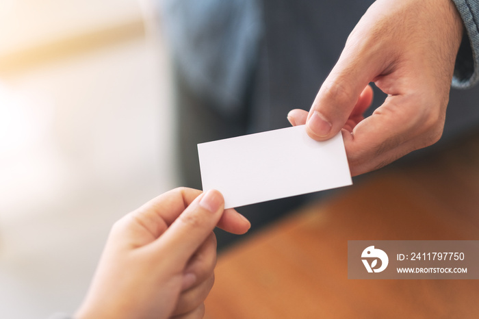 Two businessman holding and exchanging empty business card