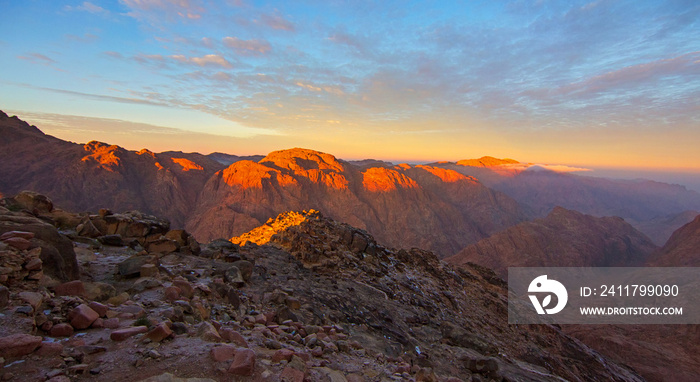 Panorama of the sunrise on the summit of the Mount Sinai (Holy Mount Moses, Mount Horeb or Jabal Mousa), Egypt, Sinai, North Africa. Low exposure