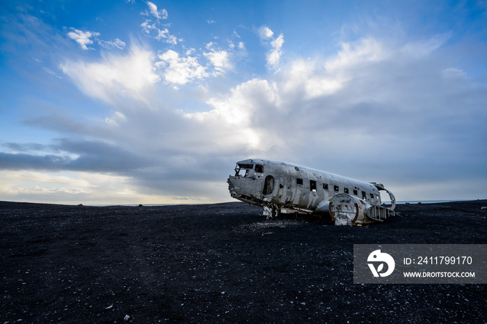 Carcass of an airplane on a black sand beach in Iceland.