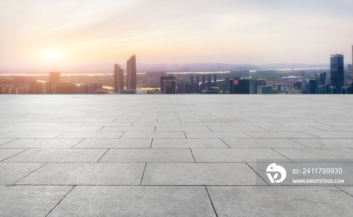 Panoramic skyline and empty square floor tiles with modern buildings